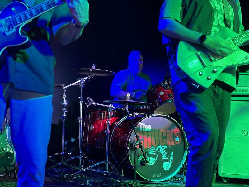 Tony driving the beat under blue and green club lights