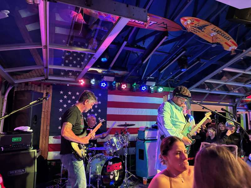 Tony and the full band performing for a lively crowd