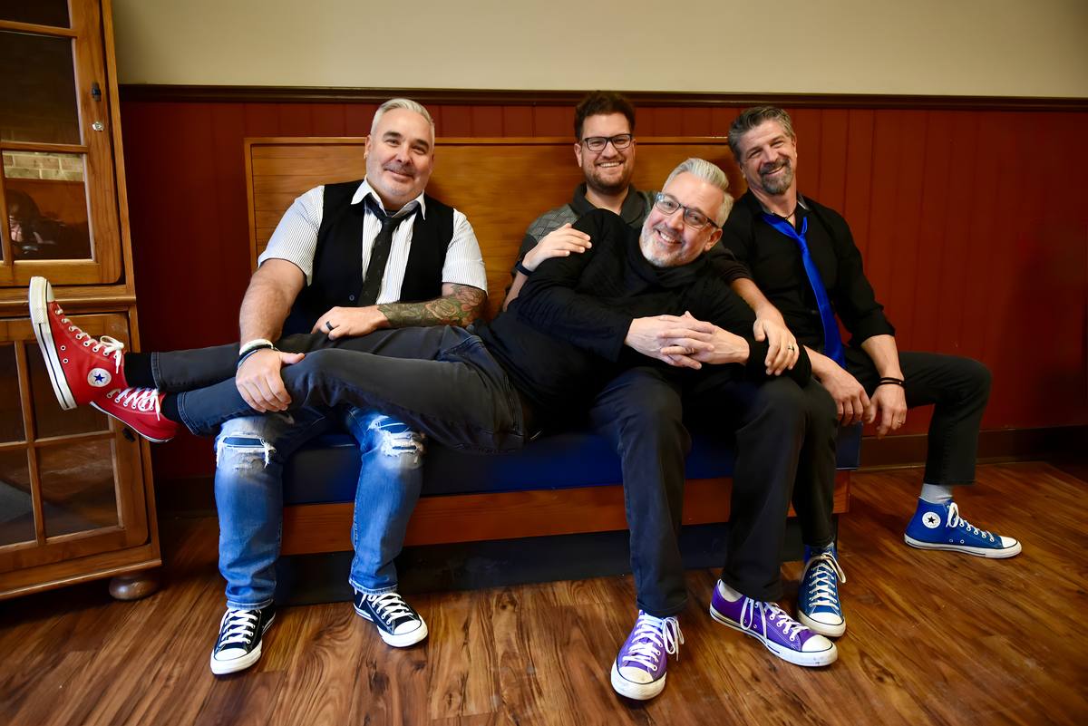 Neel, Joe, Bill, and Tony relaxing together between takes
