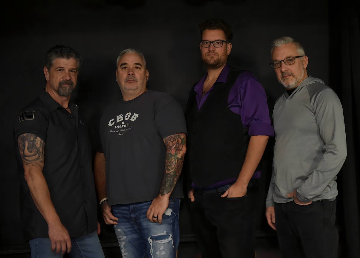 The current lineup together in a casual full-band portrait
